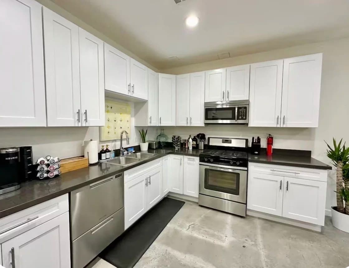 Furnished kitchen with white cabinets, stainless steel appliances and gas range in a Santa Monica monthly rental